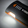Close-up of a black and orange power bank with an orange button and white indicator lights. Náhled obrázku produktu