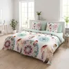 A bedroom scene with a bed dressed in a mandala and feather-patterned duvet cover and pillows. Produktbild-Vorschau