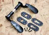 A set of black wrought iron door handles and rosettes are laid out on a light brown wooden surface. Produktbild-Vorschau