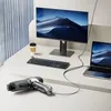A desk setup with a computer monitor, laptop, keyboard, and a handheld vacuum cleaner. Produktbild-Vorschau