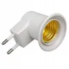 A white lamp adapter with a gold-colored socket and two prongs for plugging into an electrical outlet. Náhled obrázku produktu