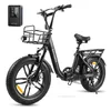 A black electric bicycle with a front basket and rear rack, shown against a white background. A small black electronic device with a screen is placed to the left of the bicycle. Produktbild-Vorschau