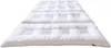 A white quilted mattress topper or duvet is shown laid out on a white background. Produktbild-Vorschau