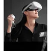 A woman wearing a VR headset and holding a controller, connected by a cable. Náhled obrázku produktu