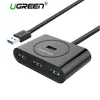 A black Ugreen USB hub with multiple ports and a connected USB cable, presented on a white background. Anteprima dell’immagine prodotto