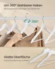 A close-up view of white wooden hangers on a clothes rack, with a hand adjusting one of the hangers. The bottom half of the image shows a close-up of more white hangers with a dashed green line indicating a smooth surface. Produktbild-Vorschau