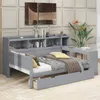 A grey daybed with storage and a pull-out drawer, styled with bedding and decorative items. Produktbild-Vorschau