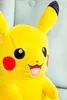 A close-up of a yellow plush toy, likely a Pikachu from Pokemon, sitting on a light green textured surface. Produktbild-Vorschau