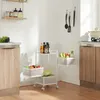 A white rolling cart with three shelves filled with vegetables and bottles of oil, placed in a kitchen setting. Podgląd zdjęcia produktu