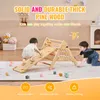 Two children playing on a wooden climbing structure indoors. Podgląd zdjęcia produktu