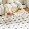 A living room scene with a couch, rug, and two nesting coffee tables. Voir les images du produit