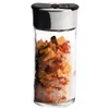A clear studio shot of a spice jar filled with salt and dried herbs. Produktbild-Vorschau