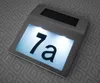 A solar-powered house number sign with the number '7a' illuminated. Podgląd zdjęcia produktu