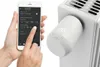 A person is using a smartphone to control a smart radiator thermostat. Náhled obrázku produktu