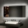 A modern bathroom vanity with a rectangular sink and a large, illuminated mirror above it.
