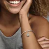 A close-up of a woman's arm wearing a Pandora bracelet with a Wall-E charm. Podgląd zdjęcia produktu