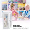 Two children are playing with dollhouse furniture in front of a dollhouse. Voir les images du produit