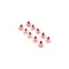 A group of ten identical red and white plastic caps arranged in a diagonal line on a white background. Náhled obrázku produktu