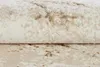 A close-up view of a rolled-up rug with a marbled pattern. Produktbild-Vorschau