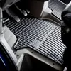 Close-up view of the interior of a car, focusing on the driver's side floor mats and pedals. Produktbild-Vorschau