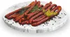 A pile of sausages on a marble plate, garnished with herbs and spices. Náhled obrázku produktu
