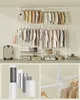 A multi-panel image showing a large, modular clothing rack filled with garments, along with a suitcase and storage items. The bottom panels highlight details of the rack's construction and accessories. Produktbild-Vorschau