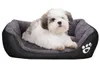 A small dog is lying in a pet bed. Anteprima dell’immagine prodotto