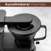 A close-up view of the filter holder of a black coffee maker. Produktbild-Vorschau