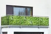 A balcony with a privacy screen featuring a wild vine pattern. Produktbild-Vorschau