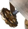 A close-up view of a decorative gear-like element attached to a wooden beam, likely part of a lamp or decorative fixture. Produktbild-Vorschau