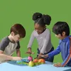 Three children are playing a board game on a table. Podgląd zdjęcia produktu