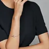 A close-up shot of a person's arm wearing a silver bracelet with a star charm. Produktbild-Vorschau