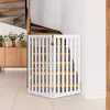 A white wooden pet gate is set up at the bottom of a staircase in a modern home. Podgląd zdjęcia produktu