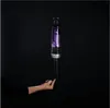 A hand is balancing a vacuum cleaner on its finger against a black background. Voir les images du produit