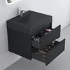 A modern black bathroom vanity with a sink and faucet, with two drawers partially open showing toiletries and brushes. Produktbild-Vorschau