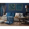 A living room scene with a sofa, coffee table, and artwork. Produktbild-Vorschau