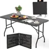 A black folding table is set up with food and drinks, and a person is shown holding another folded table.