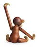 A wooden monkey toy is shown from the back, sitting with its arms and legs extended. Náhled obrázku produktu