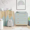 A nursery room with a changing table and storage unit. Podgląd zdjęcia produktu