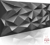 A 3D geometric wall panel with a reflective surface, casting a shadow on a white background. Anteprima dell’immagine prodotto