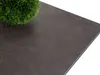 A close-up shot of a dark gray tabletop with a small green artificial plant on the left side. Náhled obrázku produktu