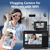 A woman is applying makeup while a digital camera, smartphone, and laptop are displayed, showing the camera's functionality for vlogging and webcam use. Produktbild-Vorschau