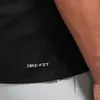 A close-up shot of the bottom hem of a black Nike shirt with the "DRI-FIT" logo visible. Podgląd zdjęcia produktu