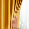A hand is shown pulling back a mustard yellow curtain, revealing a sheer white curtain behind it. Produktbild-Vorschau