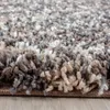 A close-up, angled view of a shaggy rug with a textured pile, showing the fibers and edge. Podgląd zdjęcia produktu
