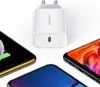 A white Ugreen USB charger is shown in the center, surrounded by three smartphones. Náhled obrázku produktu
