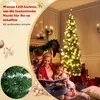 A family is reading a book in front of a decorated Christmas tree. Voir les images du produit