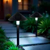 Two solar garden lights illuminating a pathway at dusk. Anteprima dell’immagine prodotto