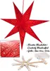 A red paper star lantern with cut-out patterns, shown hanging, with a close-up of the material and a disassembled star frame with LED lights. Produktbild-Vorschau