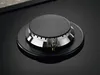 A close-up view of a gas burner on a black stovetop. Voir les images du produit